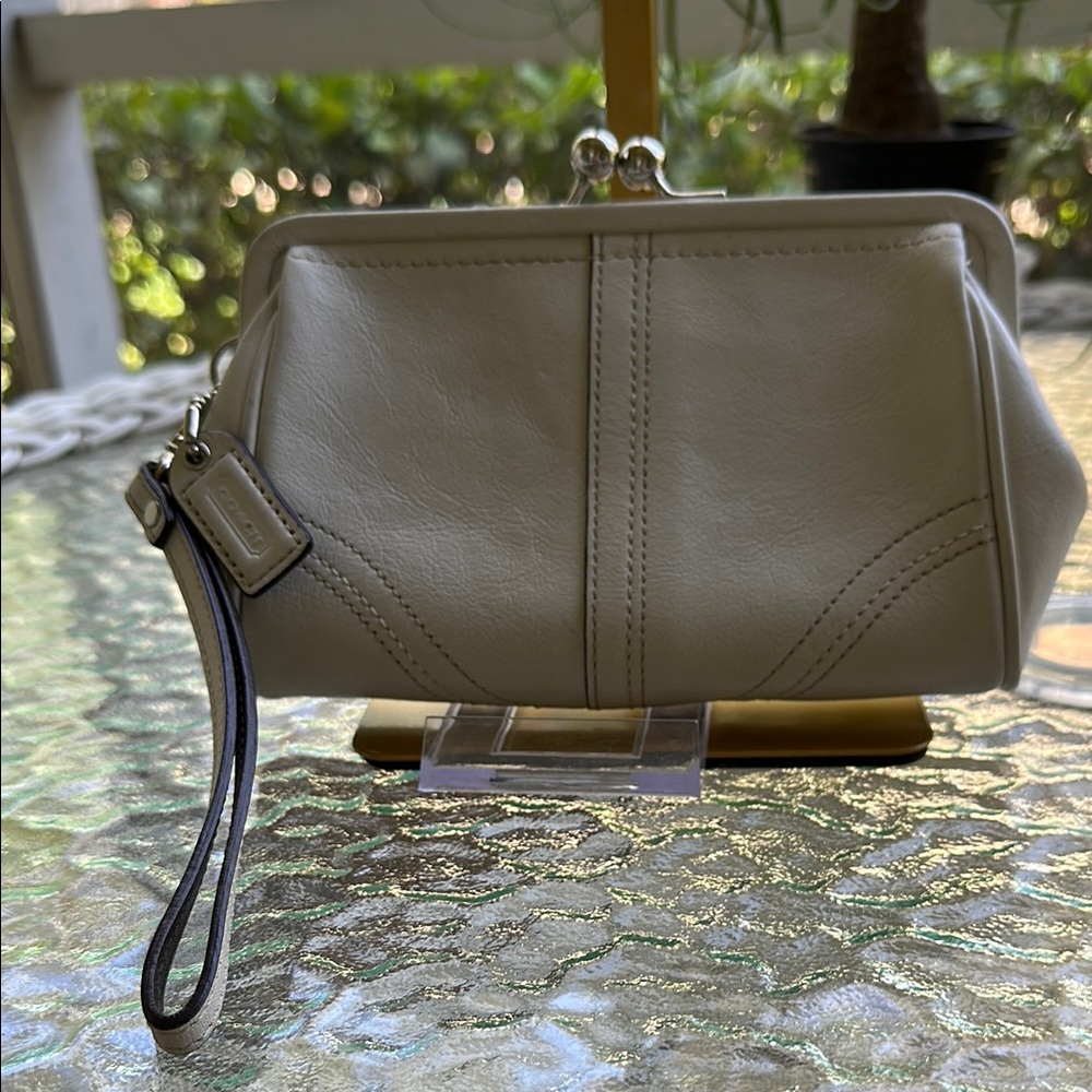 Coach off white Leather Wristlet with Kisslock  and original tag pocket inside